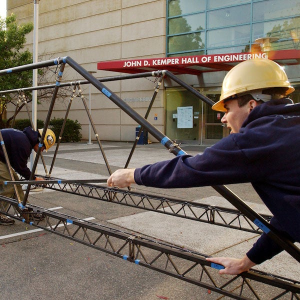 Students build an iron bridge outside of the Engineering complex at ϲʿͼ