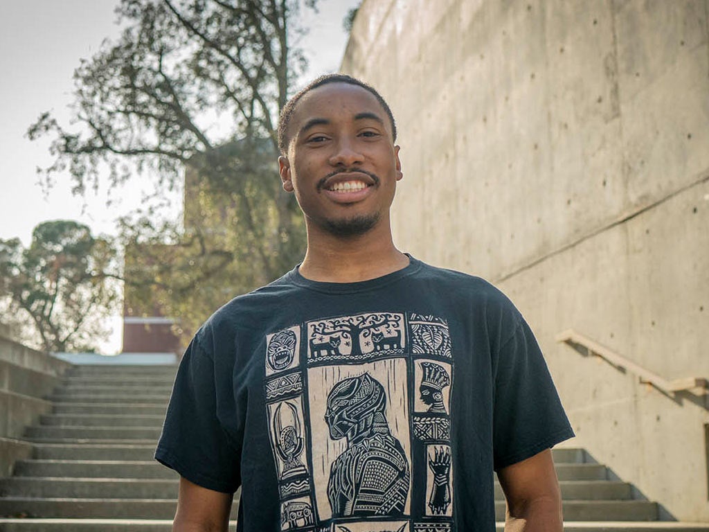 A portrait of Nate Walker standing on one of the many staircases at the Social Sciences Building on the ϲʿͼ campus