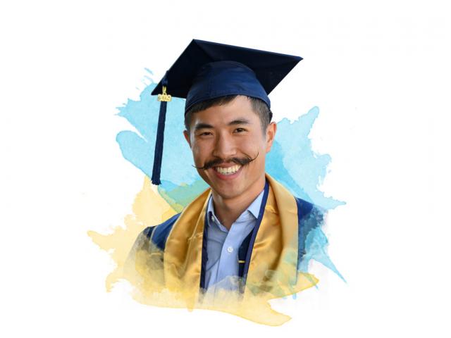 A smiling ϲʿͼ graduate with an amazing mustache