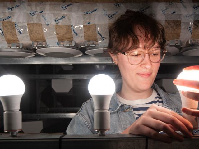 A female ϲʿͼ researchers examines some new lighting technology