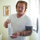 Matthew Treviño holds a canister of a hormonal birth control gel for men while in his home in Sacramento. He is part of a clinical trial at ϲʿͼ Health testing the new drug. 