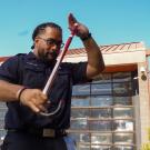 Abiel Malepeai with his fraternity cane outside the ϲʿͼ Fire Department.