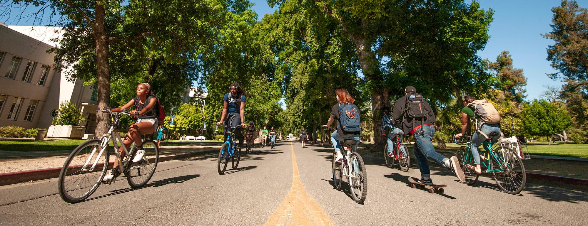 Students riding bicycles on west quad ϲʿͼ