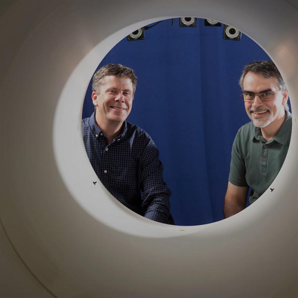 Two researchers stair through the opening to a full body PET scan maching that ϲʿͼ pioneered.