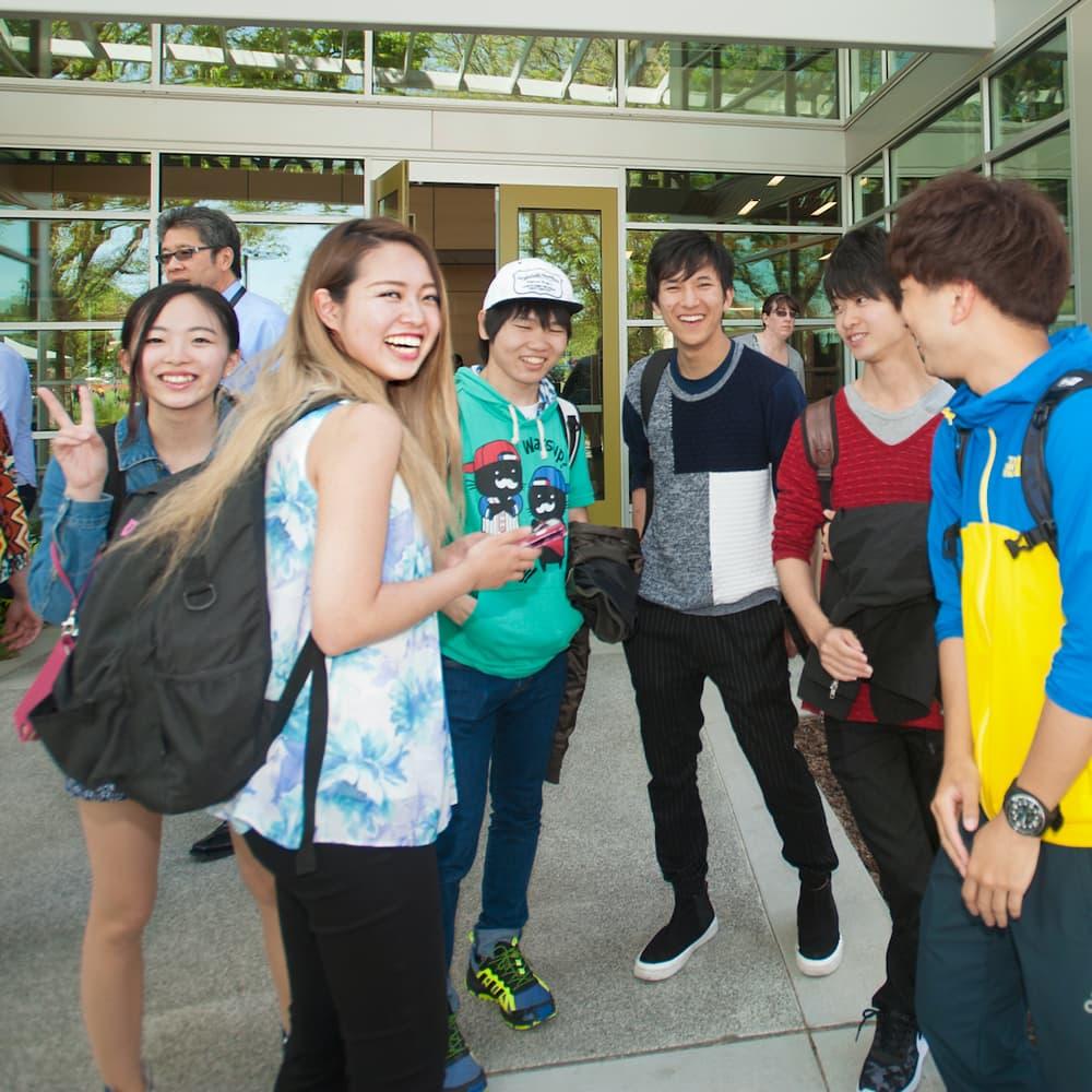 International students standing in front of the international center at ϲʿͼ.